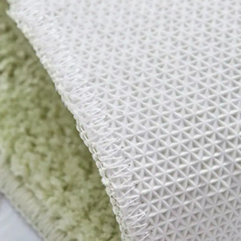 Badrumsmatta Avokado, vit textil med prickig textur och avokadofärgad yta.