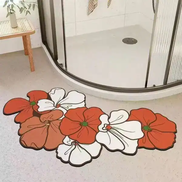Badrumsmatta med blommor i röd och vit färg, placerad framför duschen.